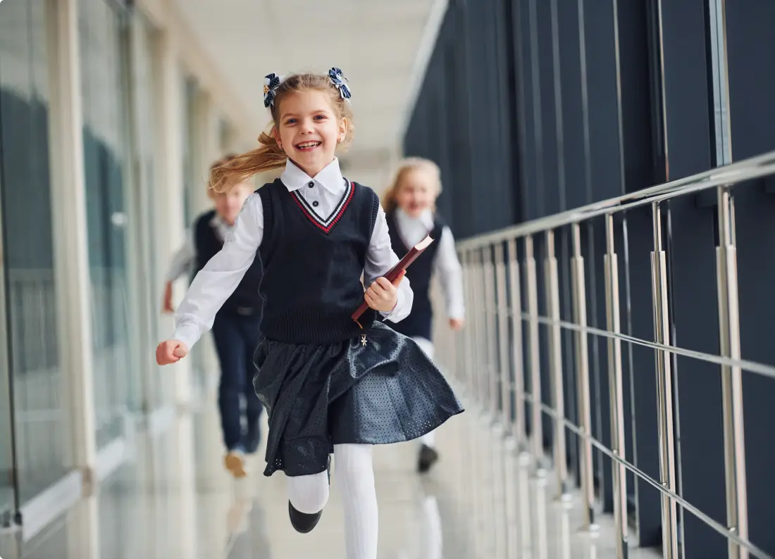 School children running along a corridor